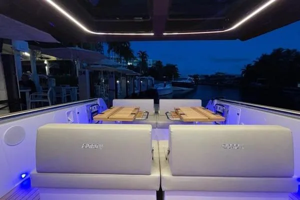 Slide: The Image of 2024 Fjord 41 XP yacht interior with ambient lighting and elegant seating at dusk. - 43