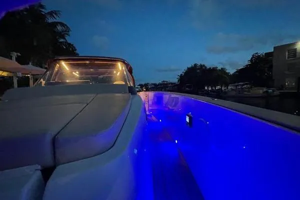 Slide: The Image of 2024 Fjord 41 XP yacht with blue LED lights at dusk. - 42