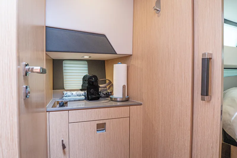 Slide: The Image of 2024 Fjord 41 XP interior kitchenette with modern appliances and wooden cabinetry. - 19