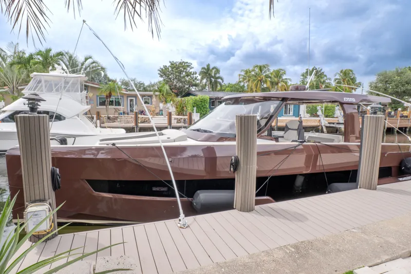 Slide: The Image of 2024 Fjord 41 XP yacht docked, surrounded by tropical scenery and palm trees. - 2