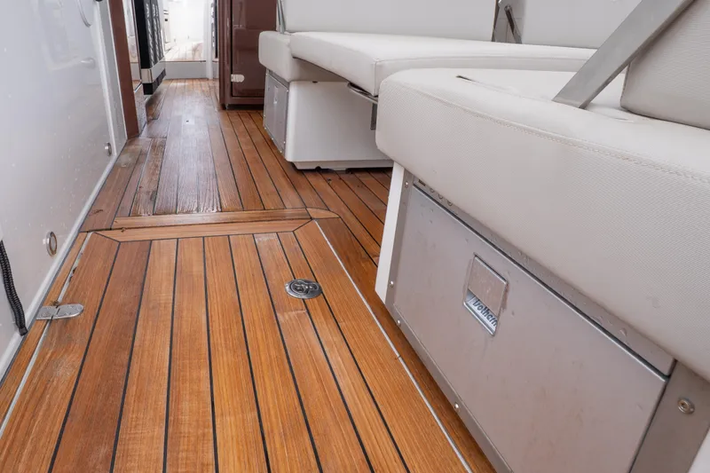 Slide: The Image of 2024 Fjord 41 XP yacht interior with teak flooring and cushioned seating. - 5