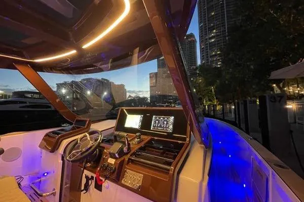 Slide: The Image of 2024 Fjord 41 XP yacht interior with illuminated dashboard and city skyline. - 39
