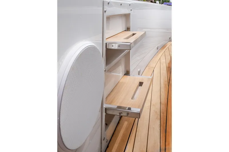 Slide: The Image of 2024 Fjord 41 XP yacht with wooden deck and built-in storage shelves. - 14