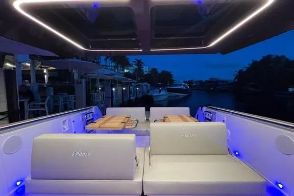 Slide: The Image of 2024 Fjord 41 XP luxury yacht interior with ambient blue lighting at dusk. - 44