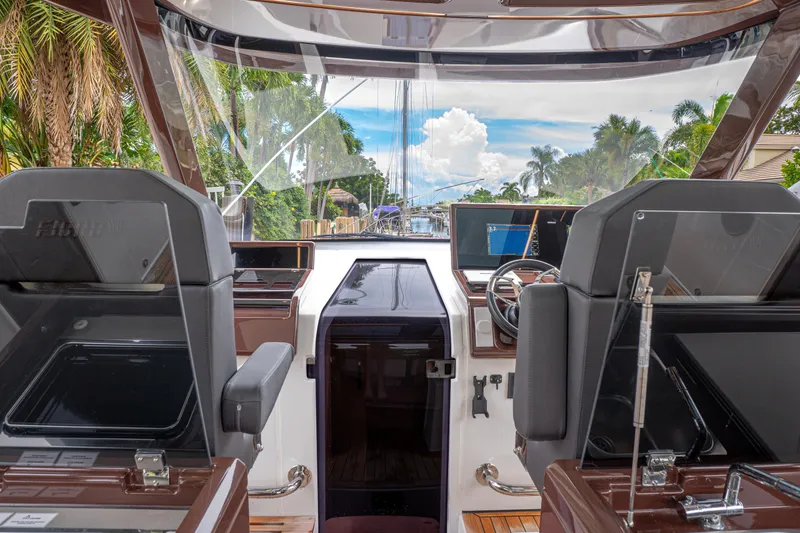 Slide: The Image of 2024 Fjord 41 XP yacht cockpit with modern controls and tropical backdrop. - 8