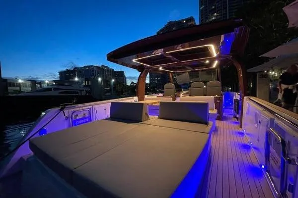 Slide: The Image of 2024 Fjord 41 XP yacht with illuminated deck at dusk, showcasing luxury seating and modern design. - 34