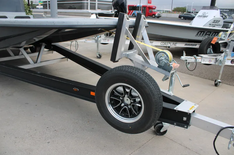 Slide: The Image of Trailer for 2026 Freedom Boats 24 Defender, featuring a sturdy wheel and winch system. - 10