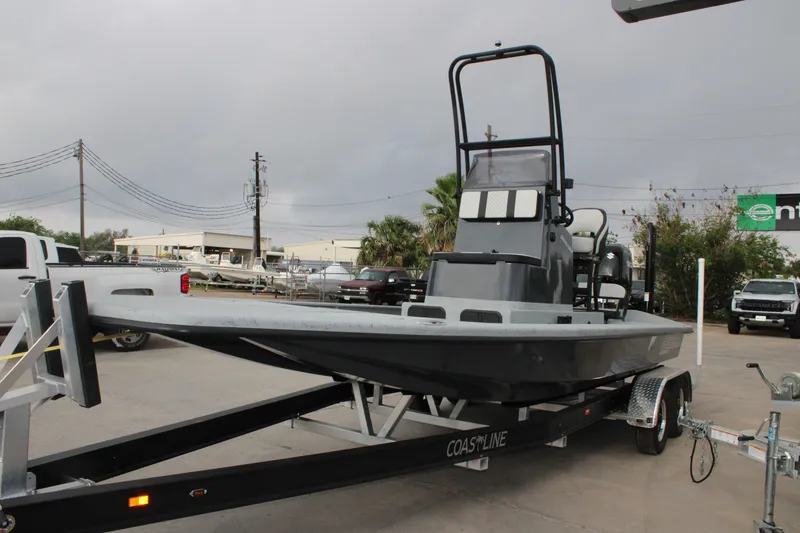 Slide: The Image of 2026 Freedom Boats 24 Defender on trailer in parking lot. - 13