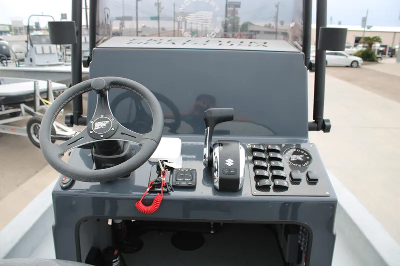Slide: The Image of 2026 Freedom Boats 24 Defender dashboard with steering wheel and control panel. - 2