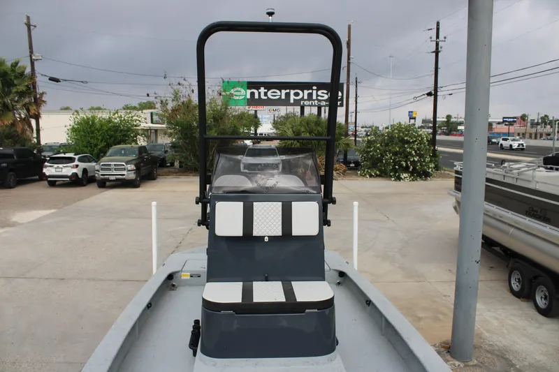 Slide: The Image of 2026 Freedom Boats 24 Defender in parking lot, overcast sky, nearby vehicles. - 22