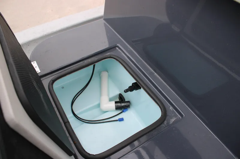 Slide: The Image of Open compartment of 2026 Freedom Boats 24 Defender, showing interior plumbing and wiring. - 23