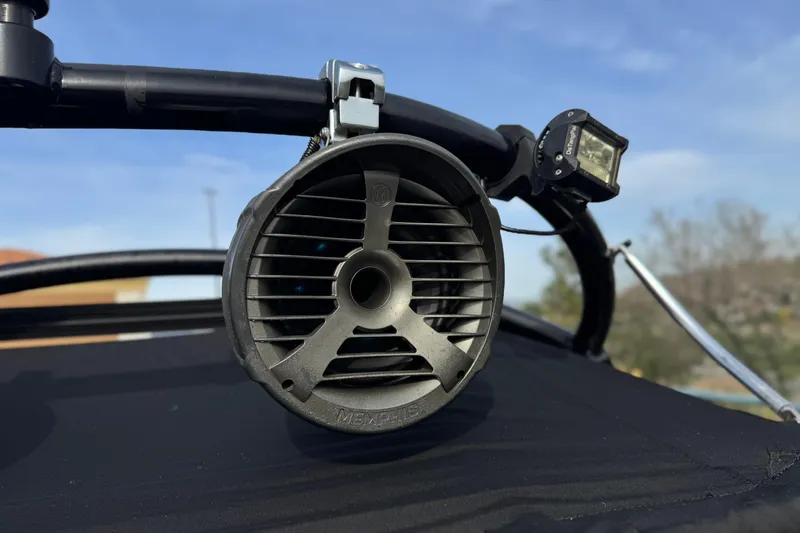 Slide: The Image of Speaker and light mounted on 2006 Tigé 22V boat, under clear blue sky. - 16