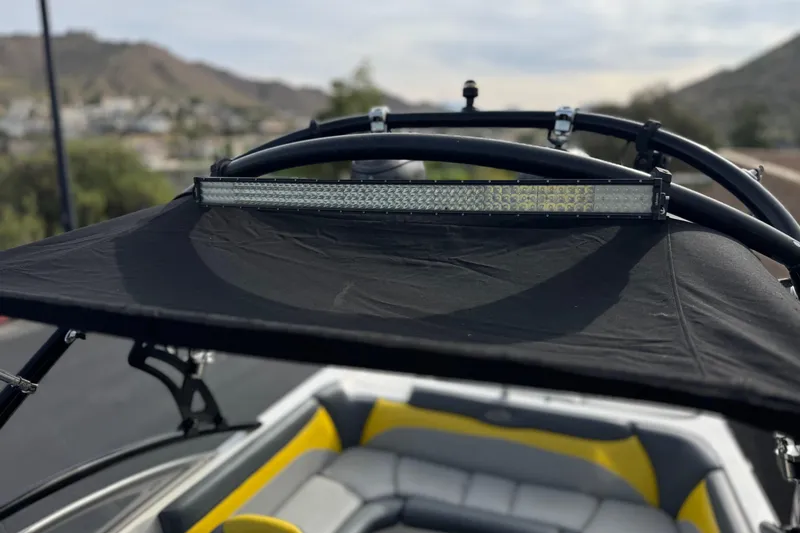 Slide: The Image of 2006 Tigé 22V boat with black canopy and LED light bar. - 18