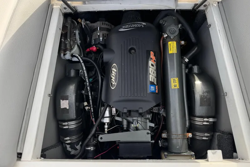 Slide: The Image of Engine compartment of a 2006 Tigé 22V boat, featuring a Vortec 5.7L 340 HP engine. - 24