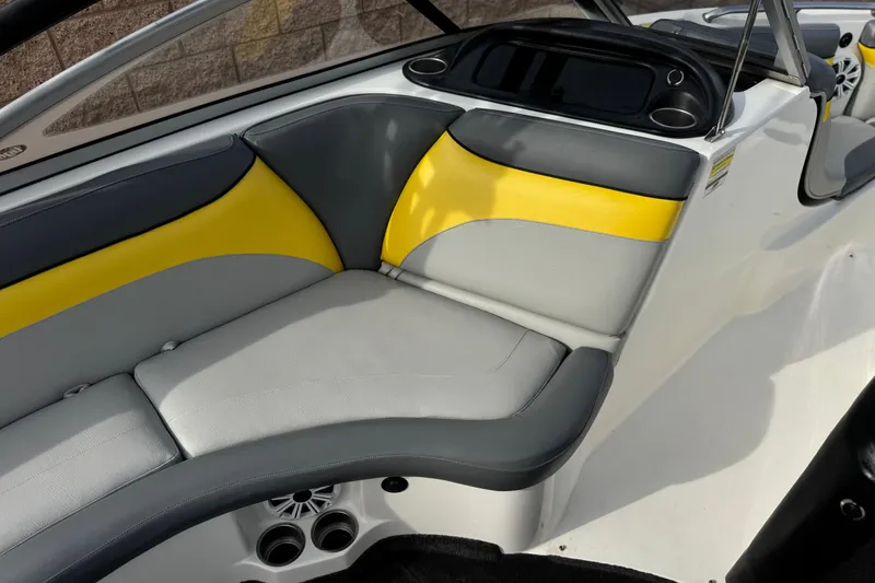Slide: The Image of 2006 Tigé 22V boat interior with gray and yellow seating. - 25