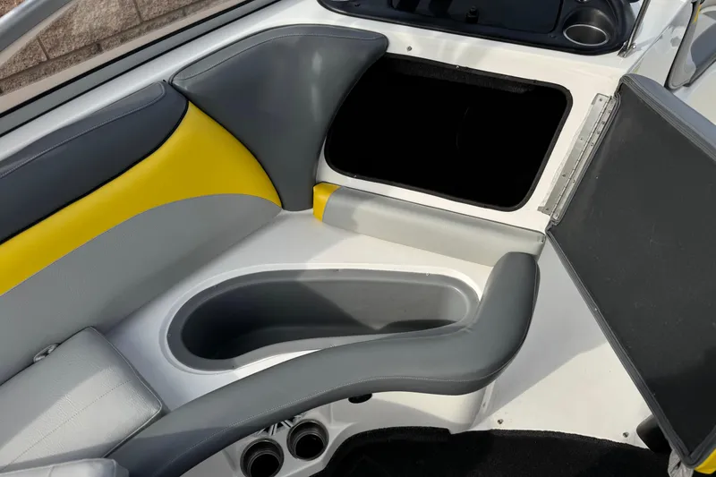 Slide: The Image of 2006 Tigé 22V boat interior with gray and yellow seating and storage compartment. - 26