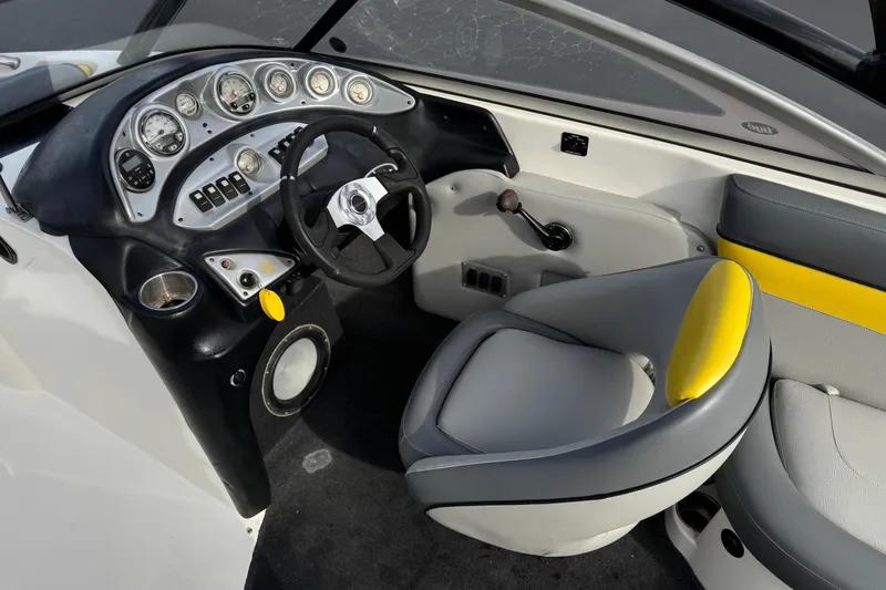 Slide: The Image of 2006 Tigé 22V boat interior with steering wheel, dashboard, and seating. - 28