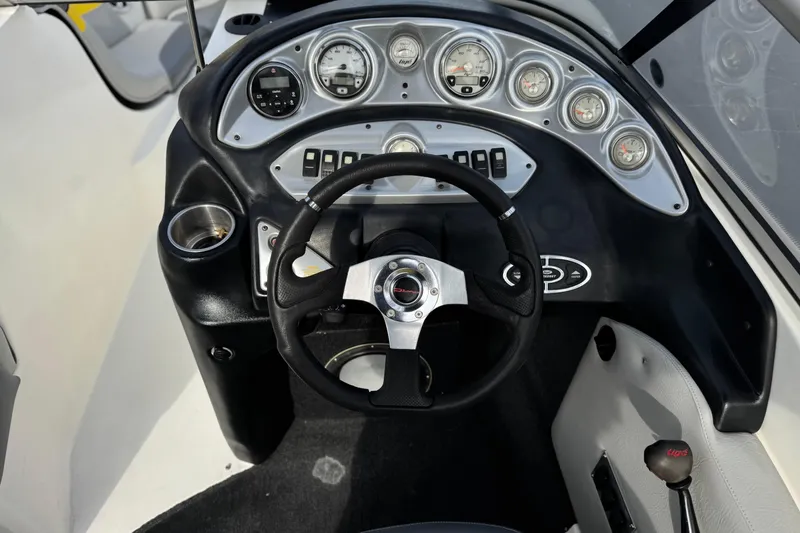 Slide: The Image of 2006 Tigé 22V boat dashboard with steering wheel and instrument panel. - 29