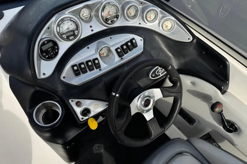 Slide: The Image of Dashboard of a 2006 Tigé 22V boat with gauges and steering wheel. - 30