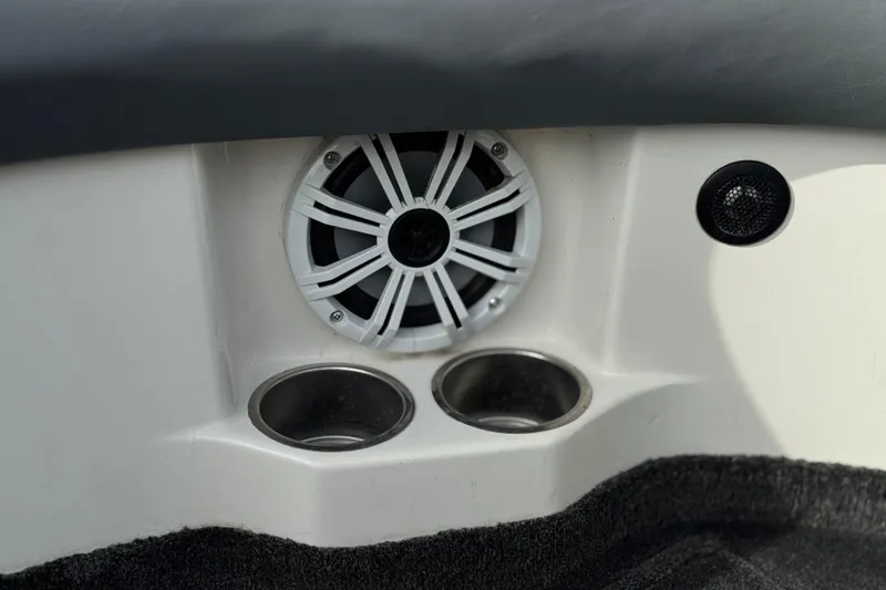 Slide: The Image of Speaker and cup holders in a 2006 Tigé 22V boat interior. - 32