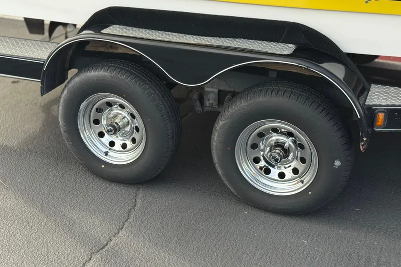 Slide: The Image of Dual wheels on a 2006 Tigé 22V boat trailer, featuring chrome rims. - 33