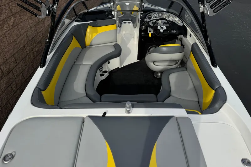Slide: The Image of 2006 Tigé 22V boat interior with gray and yellow seating, sleek dashboard, and modern design. - 9