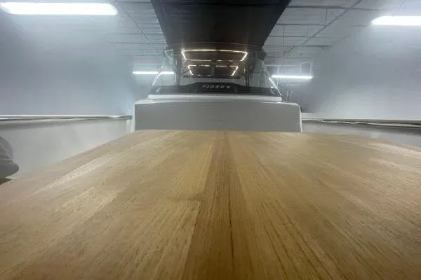 Slide: The Image of 2023 Fjord 38 Xpress boat with wooden deck in a showroom. - 23