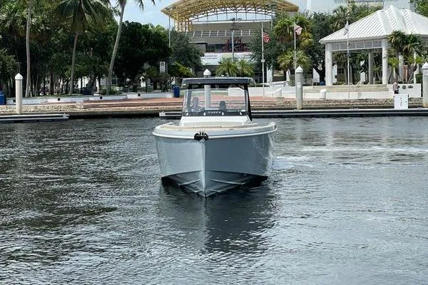Slide: The Image of 2023 Fjord 38 Xpress boat cruising in a scenic waterfront setting. - 3