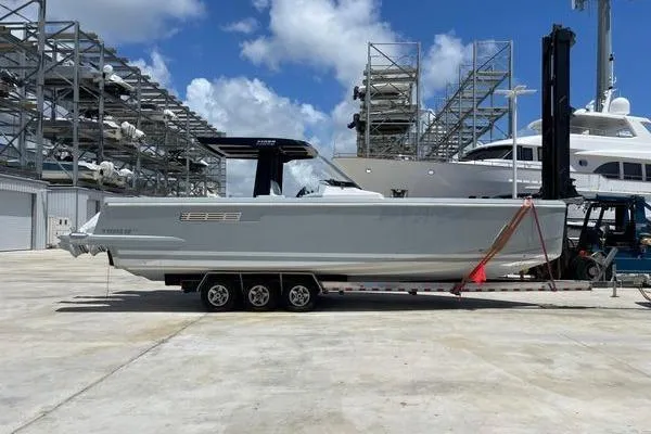 Slide: The Image of 2023 Fjord 38 Xpress boat on trailer at marina with blue sky background. - 7