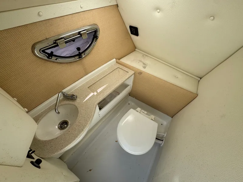 Slide: The Image of Interior of a 2017 Cobalt R5 boat cabin with toilet and sink. - 24