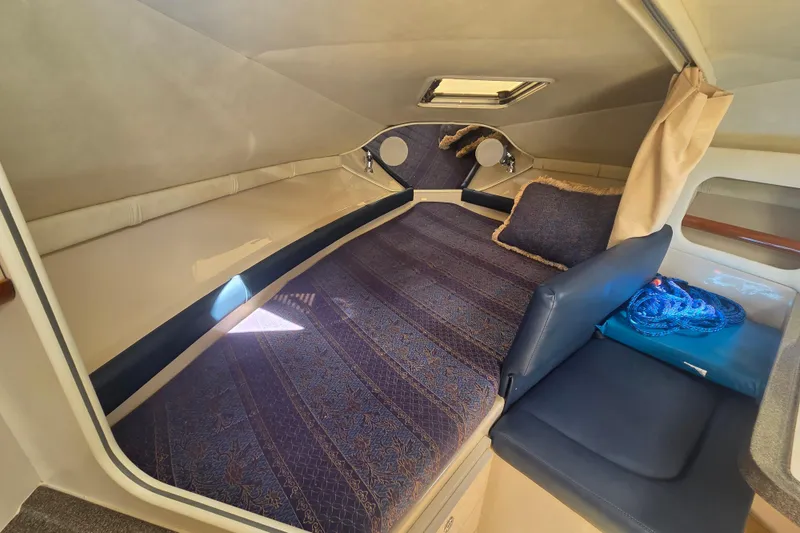 Slide: The Image of Interior cabin of 2001 Doral 270 SC boat with cozy seating and nautical decor. - 16