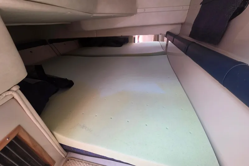 Slide: The Image of Interior cabin of a 2001 Doral 270 SC boat with a foam mattress. - 18