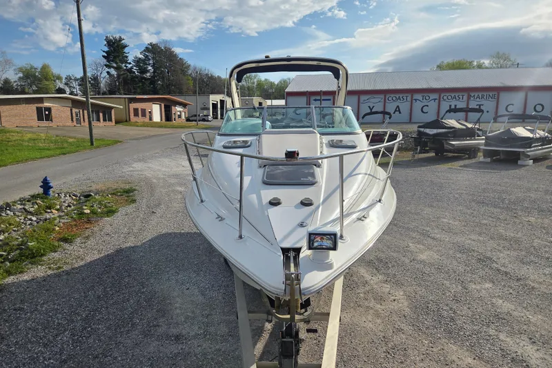 Slide: The Image of 2001 Doral 270 SC boat on trailer at a marine dealership. - 2