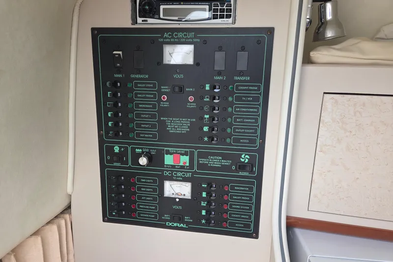 Slide: The Image of Electrical control panel on a 2001 Doral 270 SC boat, featuring AC and DC circuits. - 23