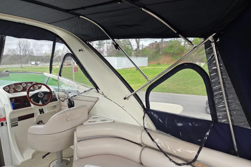 Slide: The Image of Interior view of a 2001 Doral 270 SC boat with seating and steering wheel. - 24