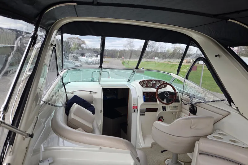 Slide: The Image of Interior view of 2001 Doral 270 SC boat cockpit with steering wheel and seating. - 26