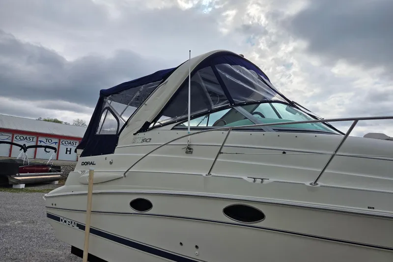 Slide: The Image of 2001 Doral 270 SC boat with canopy under cloudy sky. - 27