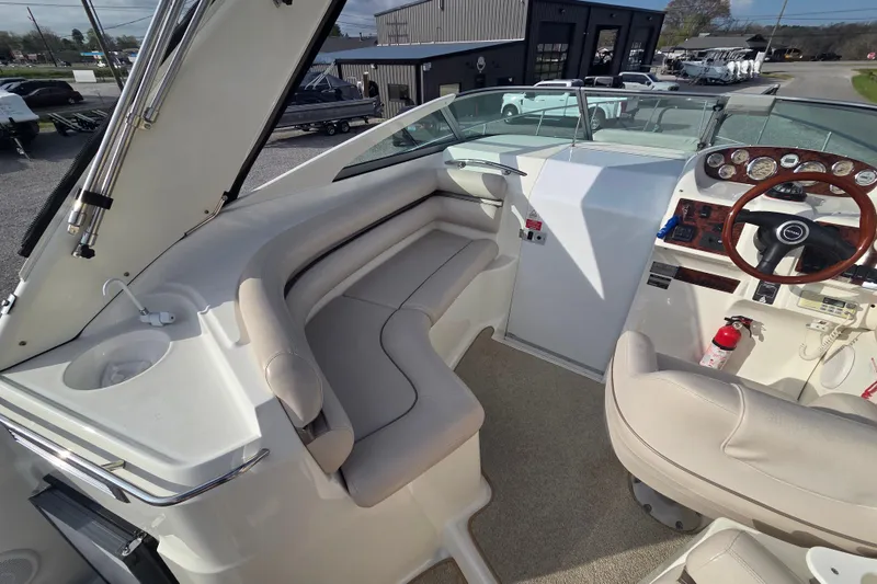 Slide: The Image of 2001 Doral 270 SC boat interior with beige seating and wooden steering wheel. - 7