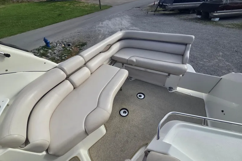 Slide: The Image of 2001 Doral 270 SC boat interior with beige seating and carpeted floor. - 9
