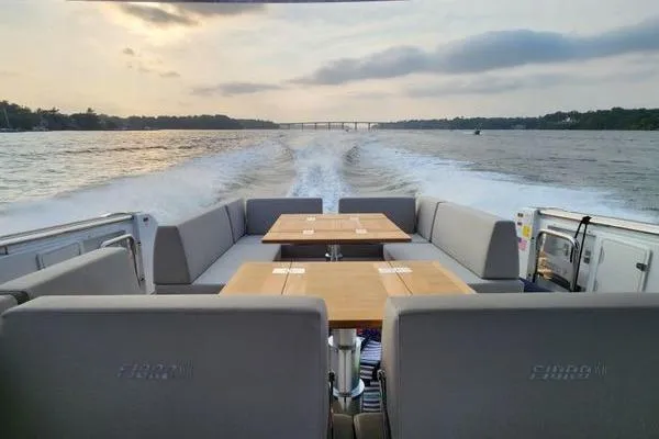Slide: The Image of 2023 Fjord 41 XL yacht cruising on a serene waterway at sunset. - 12