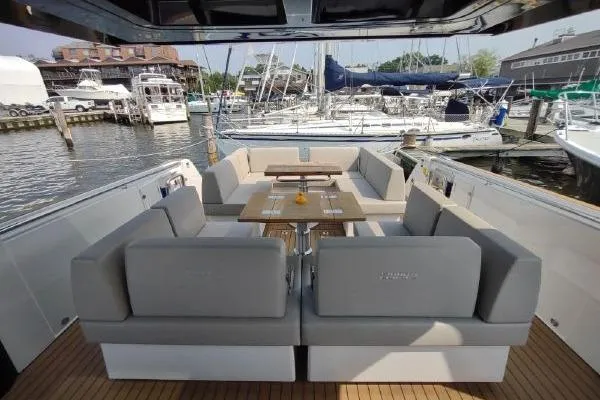 Slide: The Image of Luxurious 2023 Fjord 41 XL yacht interior with elegant seating and marina view. - 16
