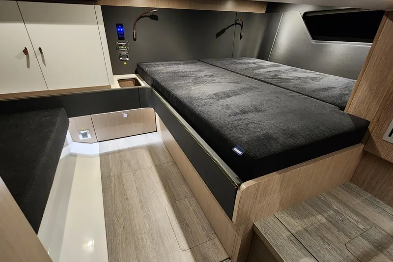 Slide: The Image of 2023 Fjord 41 XL cabin interior with modern wood finish and cozy bedding. - 37