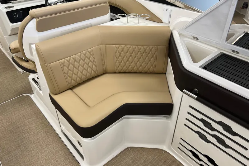 Slide: The Image of Luxurious seating on 2024 Sea Ray SLX 310 boat, featuring tan upholstery and elegant design. - 10