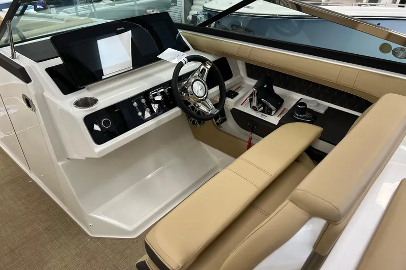 Slide: The Image of 2024 Sea Ray SLX 310 helm with modern controls and beige seating. - 11