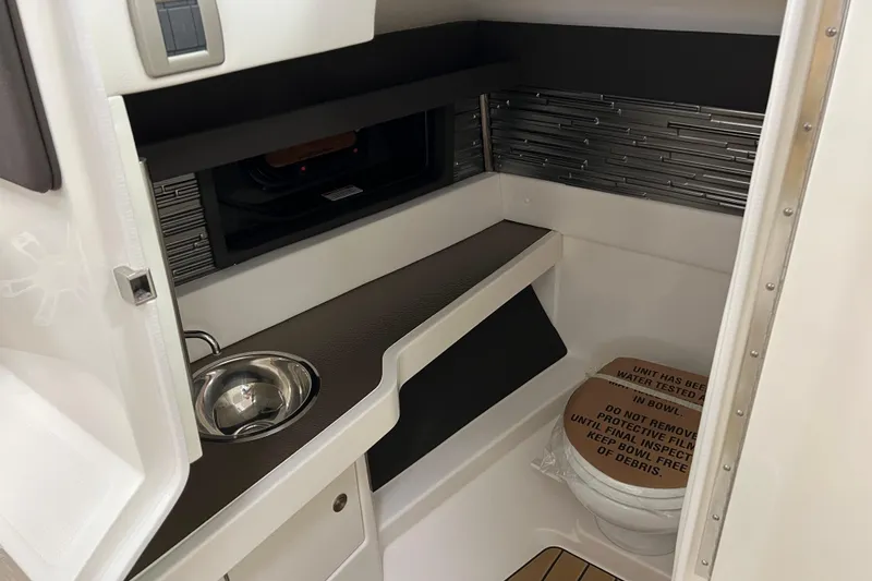 Slide: The Image of 2024 Sea Ray SLX 310 interior cabin with sink and toilet. - 16