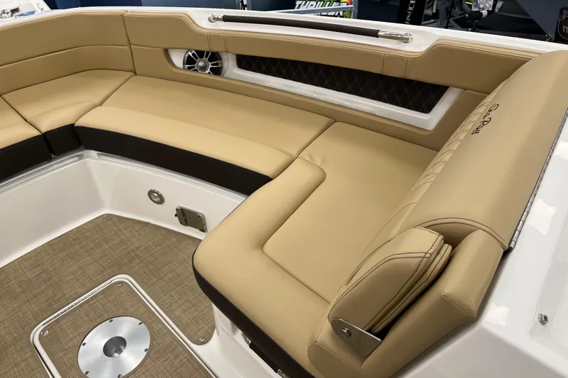 Slide: The Image of 2024 Sea Ray SLX 310 boat interior with tan leather seating and modern design. - 19