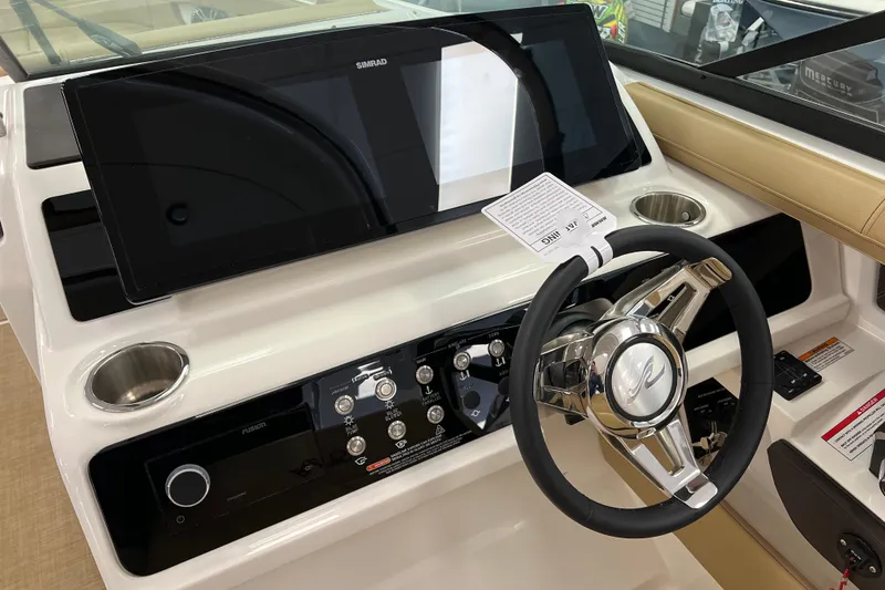 Slide: The Image of 2024 Sea Ray SLX 310 helm with modern controls and sleek steering wheel design. - 36