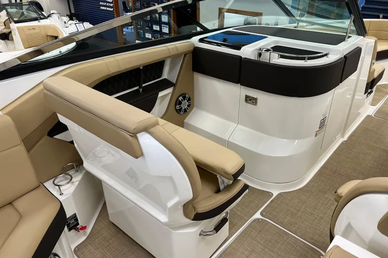 Slide: The Image of 2024 Sea Ray SLX 310 boat interior with beige seating and modern design. - 38