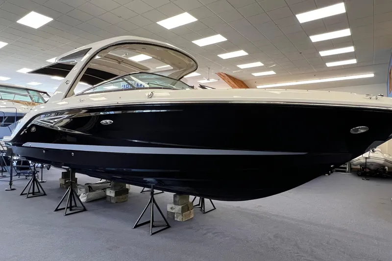 Slide: The Image of 2024 Sea Ray SLX 310 boat displayed indoors on stands. - 4