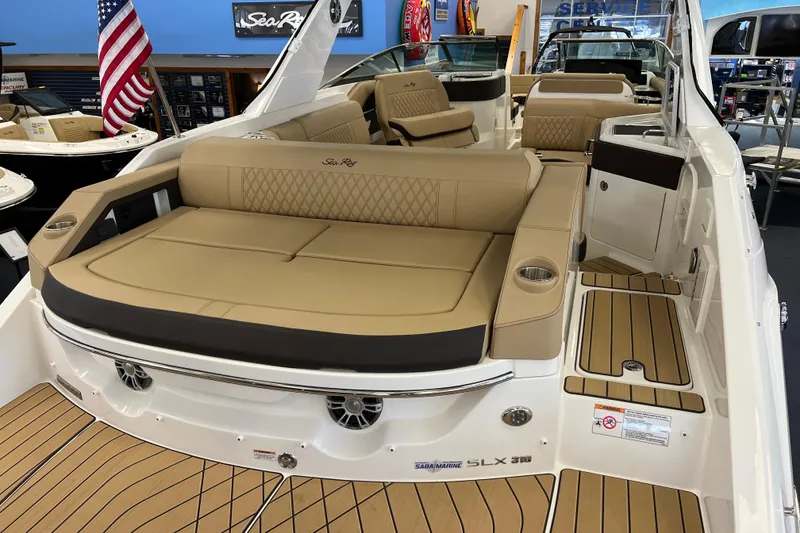 Slide: The Image of 2024 Sea Ray SLX 310 boat interior with tan seating and American flag display. - 5